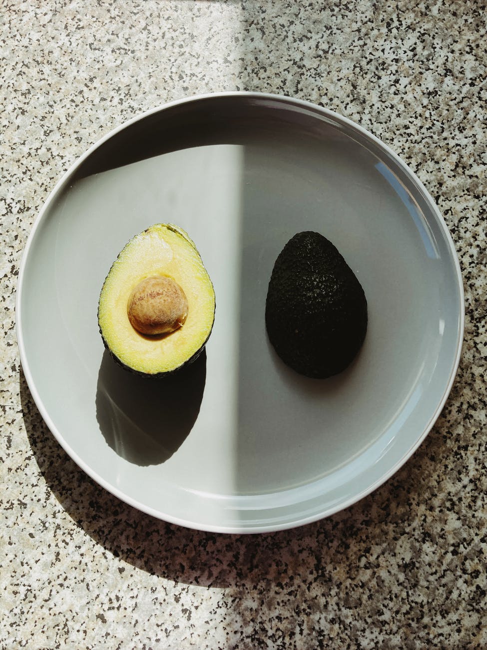 parts of healthy avocado on plate